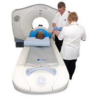 Patient lying on a CT scanner table with two medical professionals standing nearby.