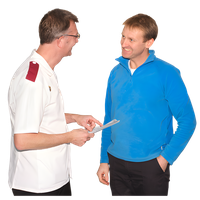 Two men, one in a white shirt and one in a blue fleece jacket, having a friendly conversation.