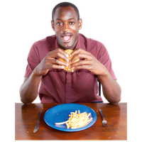Man eating a sandwich with a plate of French fries in front of him.