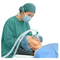 A medical professional in green scrubs administering anaesthesia to a patient.