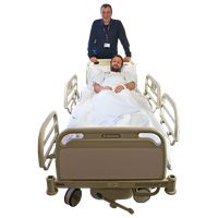 Patient lying in a hospital bed with a healthcare professional standing behind.