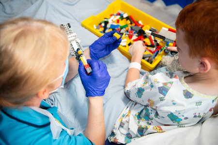 Clinician and child play with lego