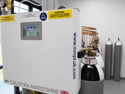 A medical air manifold unit connected to multiple compressed gas cylinders within a newly refurbished plant room. The system includes a touchscreen monitoring display and manifold controls that manage the supply and distribution of medical air. Additional reserve cylinders are visible in the background, supporting continuity and resilience of the medical gas infrastructure.