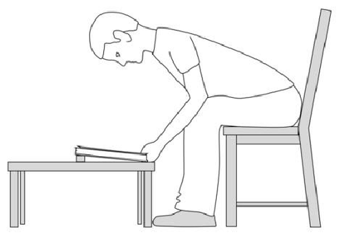Reading a book from a low table with head in face down position