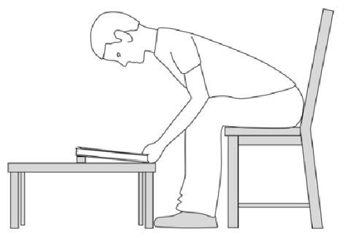 Reading a book from a low table with head in face down position