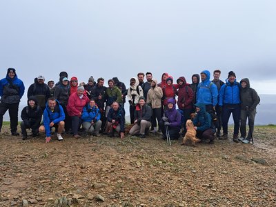 Sam and a group of family, friends, emergency service personnel and supporters gather on the summit of Helvellyn after completing the charity walk.