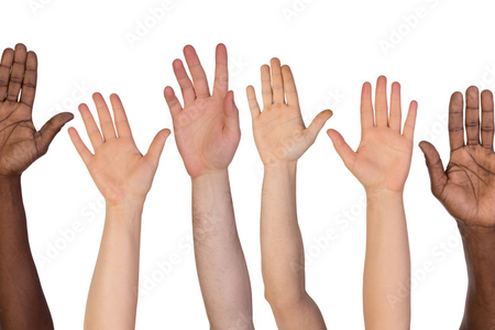 Photograph of multiple raised hands with open palms facing forward, arranged side by side against a plain light grey background. The hands are shown from the forearm upwards and vary in size and appearance, representing a diverse group of people.